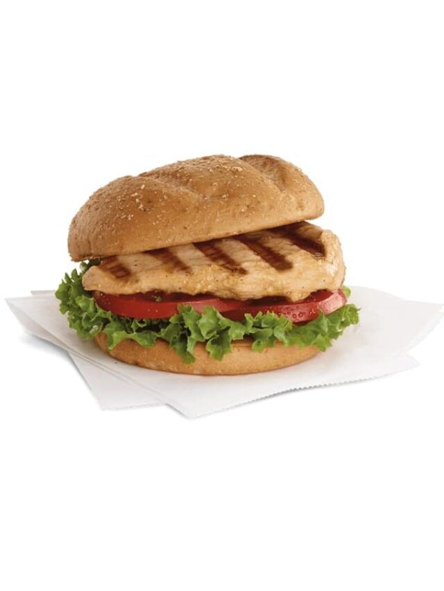 A chick fil a grilled chicken sandwich with lettuce and tomato.