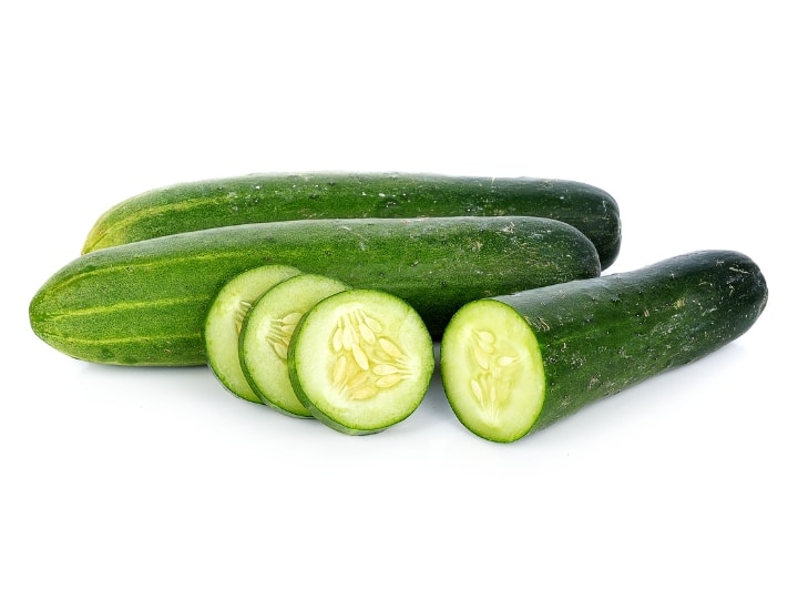 A couple of cucumbers with one of them sliced.