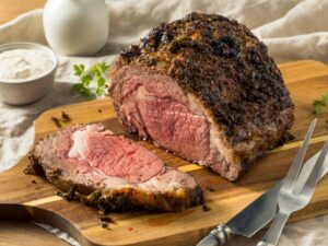 An eye round roast beef with a slice cut from the front of it.