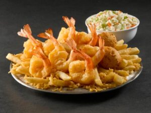 A bunch of battered shrimp on a plate.