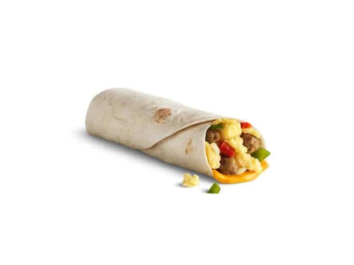 A tortilla wrap with sausage, egg, cheese, and peppers in it.