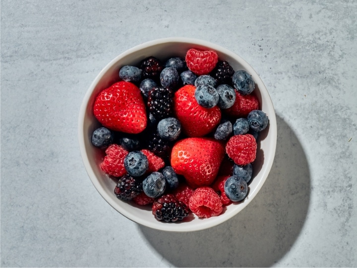 A bowl of mixed blueberries, strawberries, and raspberries.