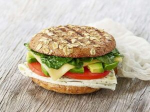 A panera avocado, egg white, spinach, and cheese sandwich on a grain flat bread.