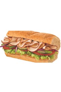 Half of a Subway turkey sub with tomatoes, lettuce, and onion.