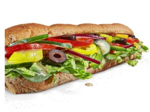 A vegetable sub with lettuce, peppers, tomatoes, olives, and cucumbers.