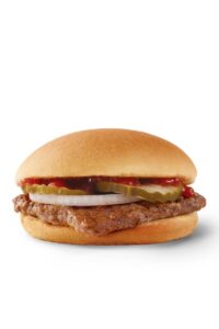 A Wendy's jr hamburger with ketchup, pickles, and onions.