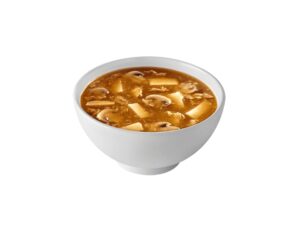 A white bowl filled with hot and sour soup.