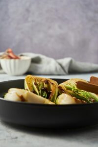 Cooked bok choy in a skillet.