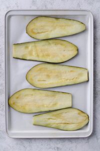 Thinly cut eggplant on a baking sheet lined with parchment paper.