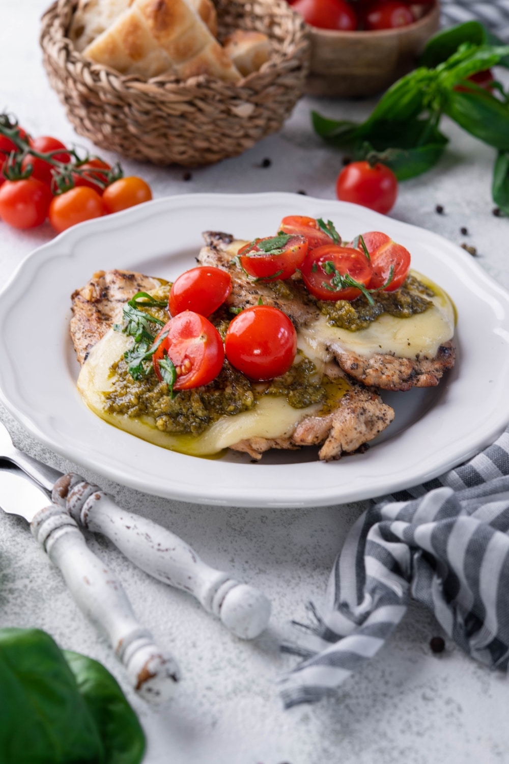 Grilled chicken margherita served on a white plate.