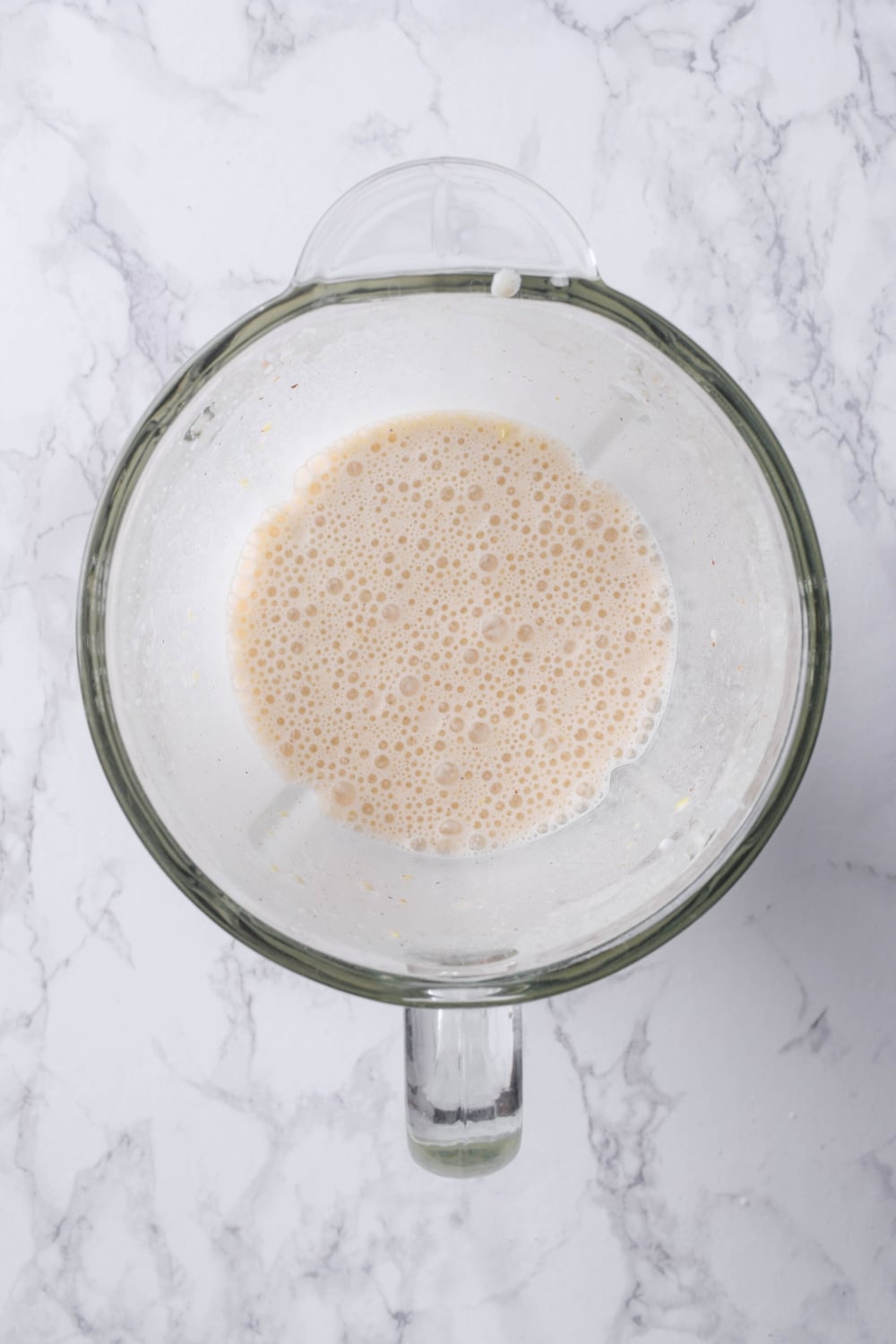 A banana protein shake in a blender.