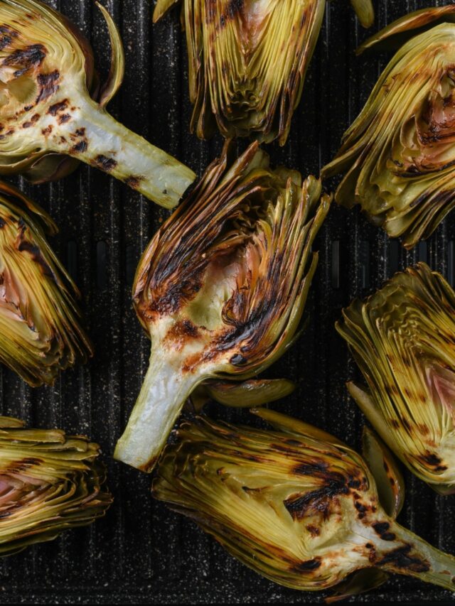 Grilled artichoke halves on an electric grill.
