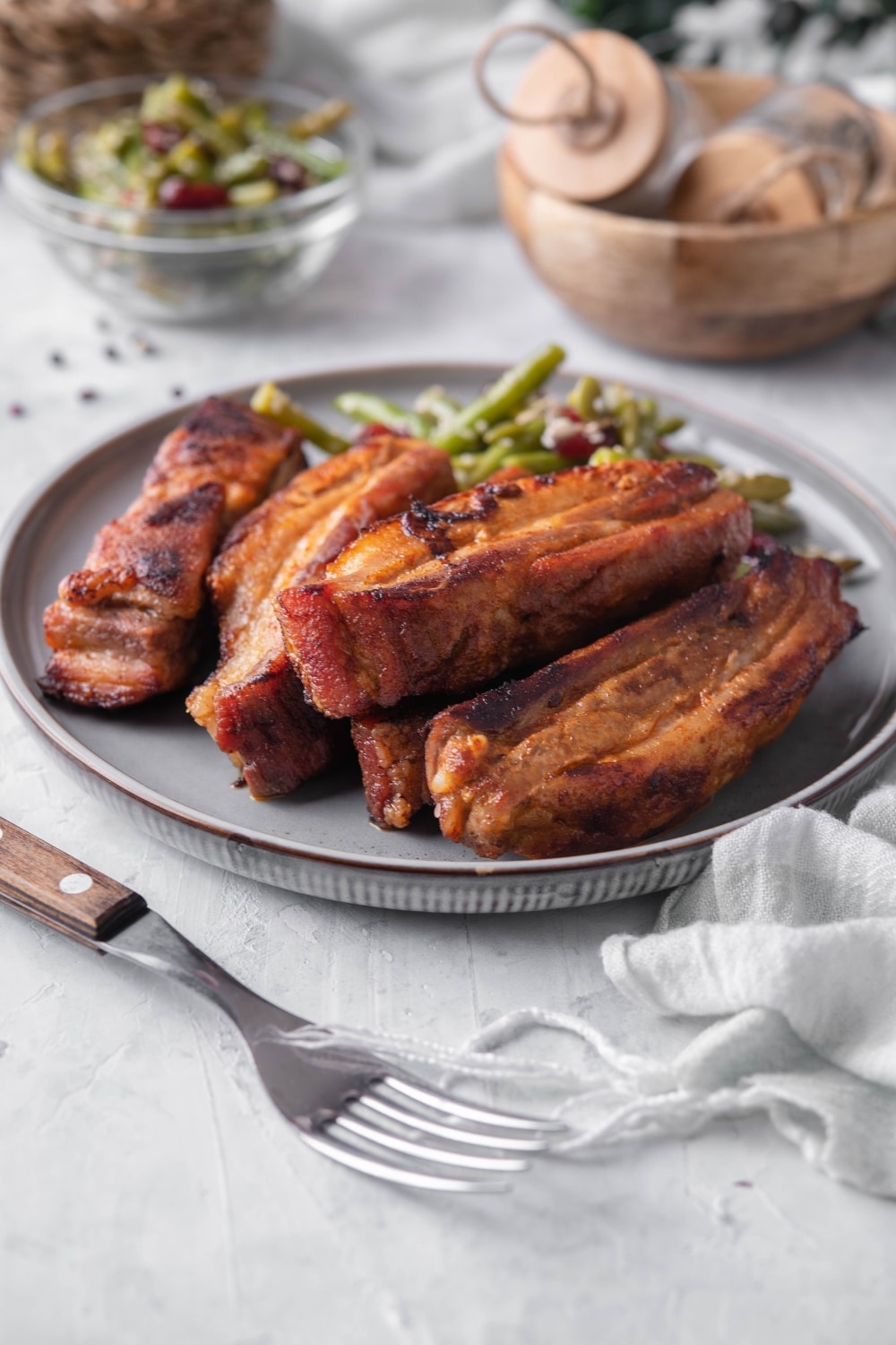 Roasted pork belly strips with green bean salad.