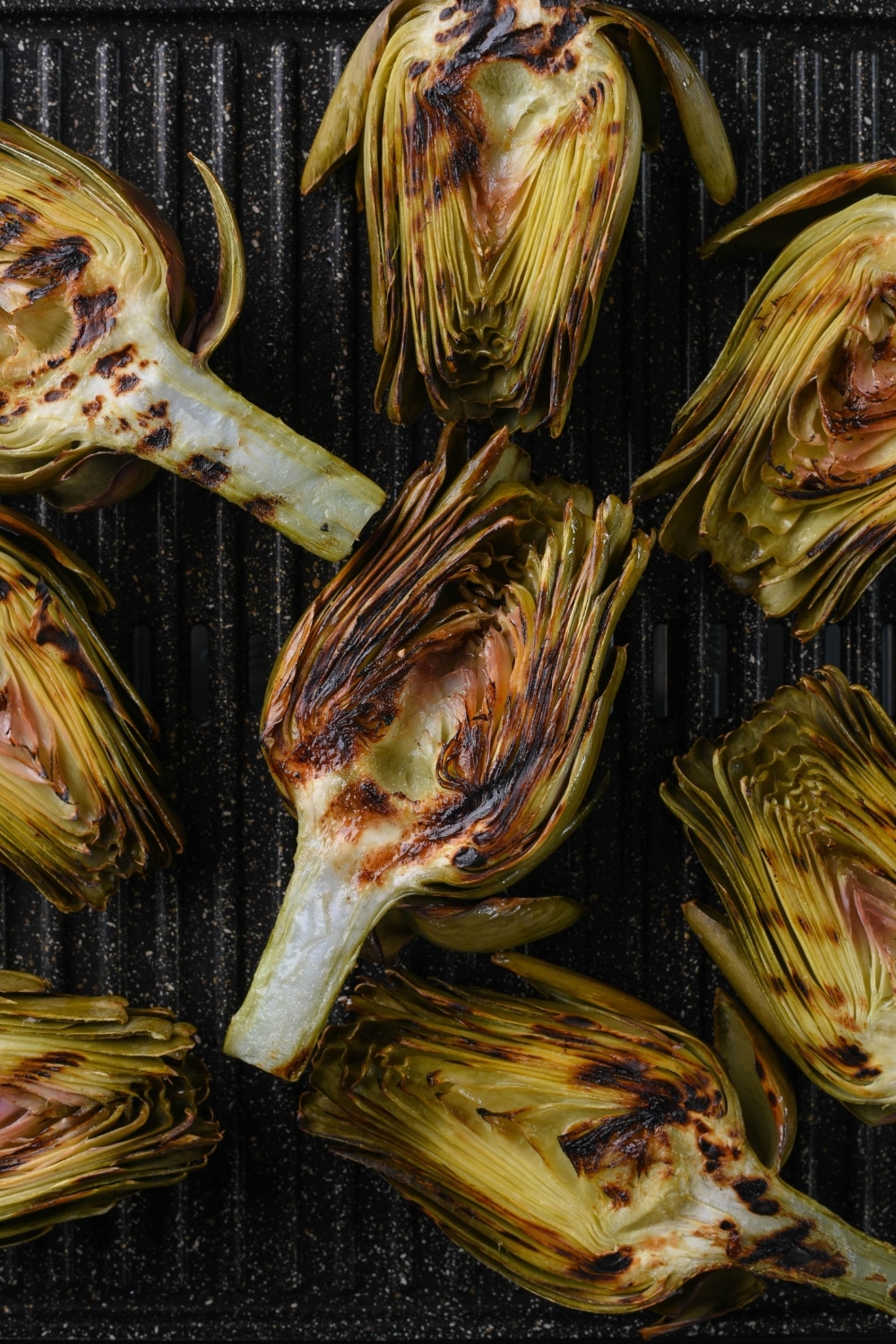 Grilled artichoke halves on an electric grill.