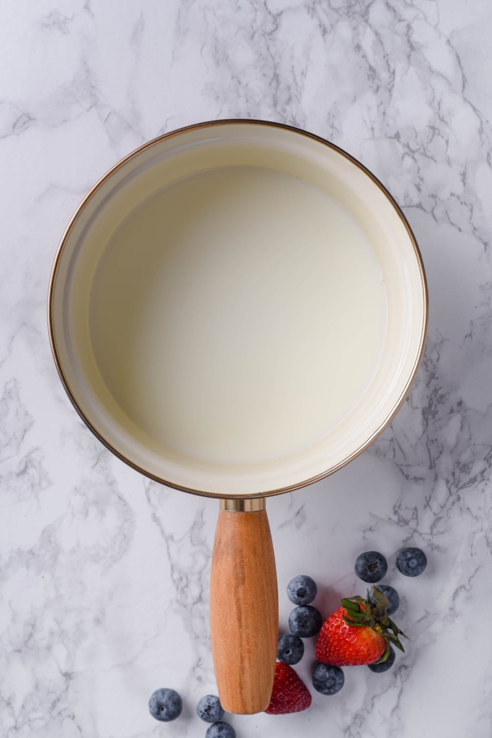 Top view of a saucepan filled with almond milk.