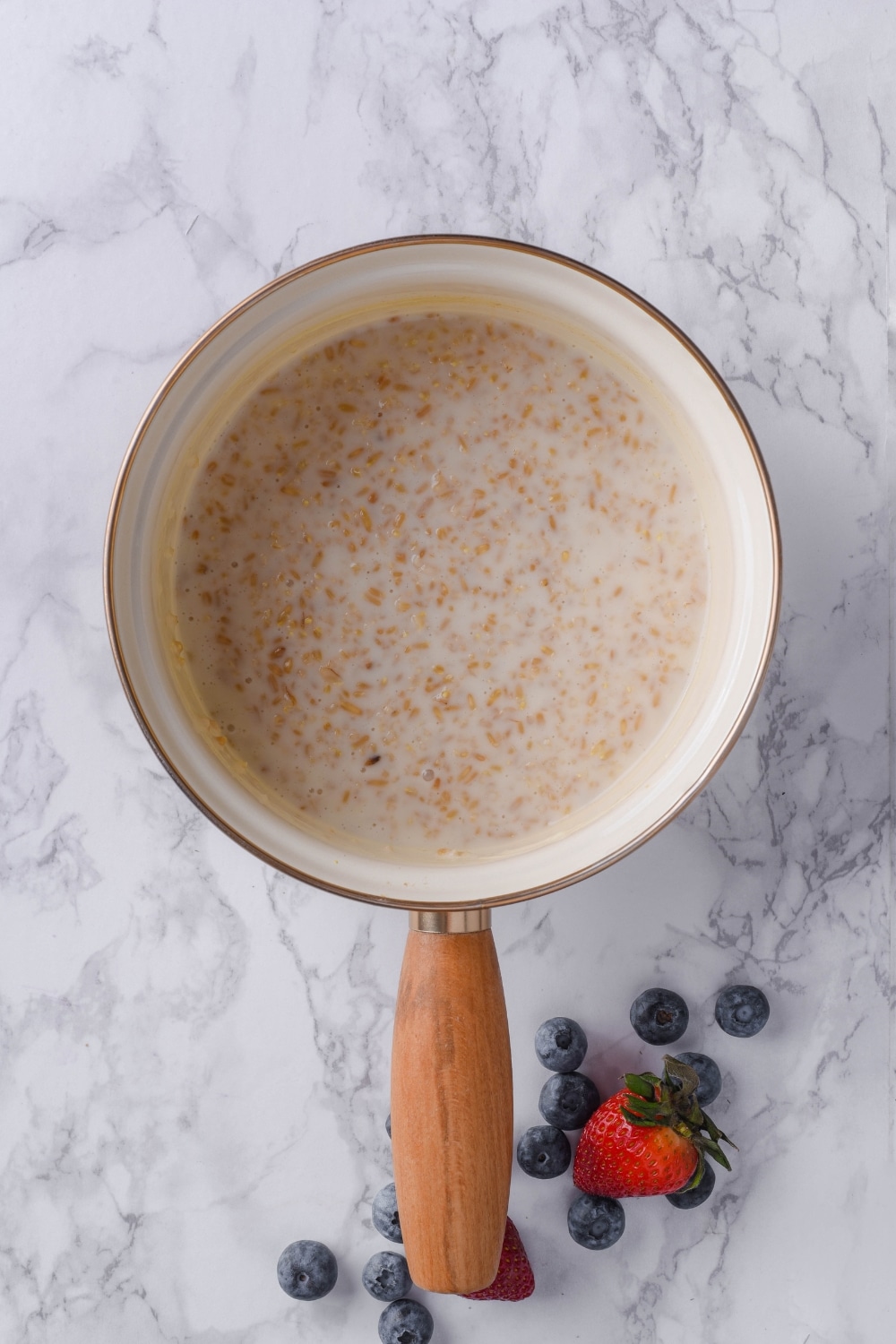 Top view of cooked steel cut oats in a saucepan.