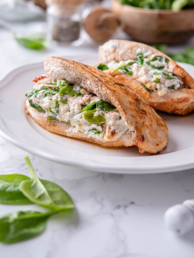 Two stuffed chicken breasts filled with cream cheese, spinach, and sundried tomatoes.