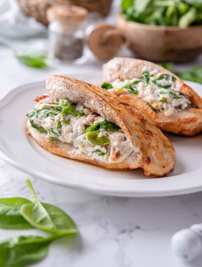 Two stuffed chicken breasts filled with cream cheese, spinach, and sundried tomatoes.