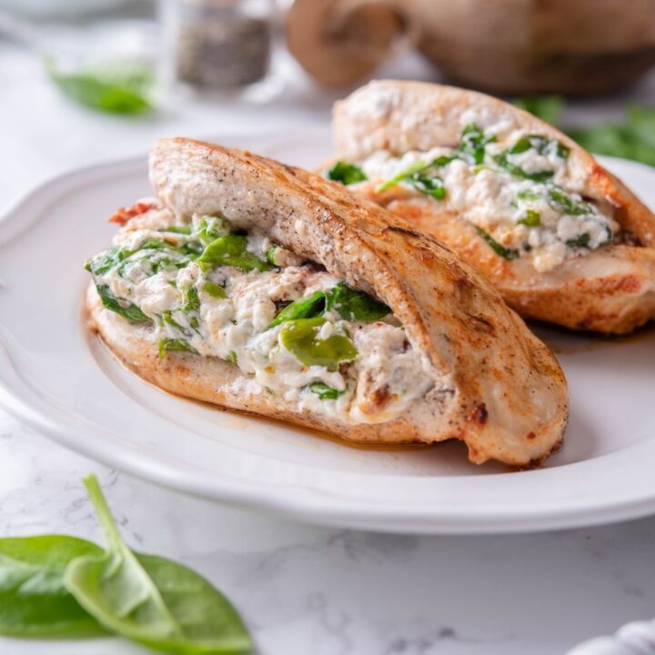 Two stuffed chicken breasts filled with cream cheese, spinach, and sundried tomatoes.