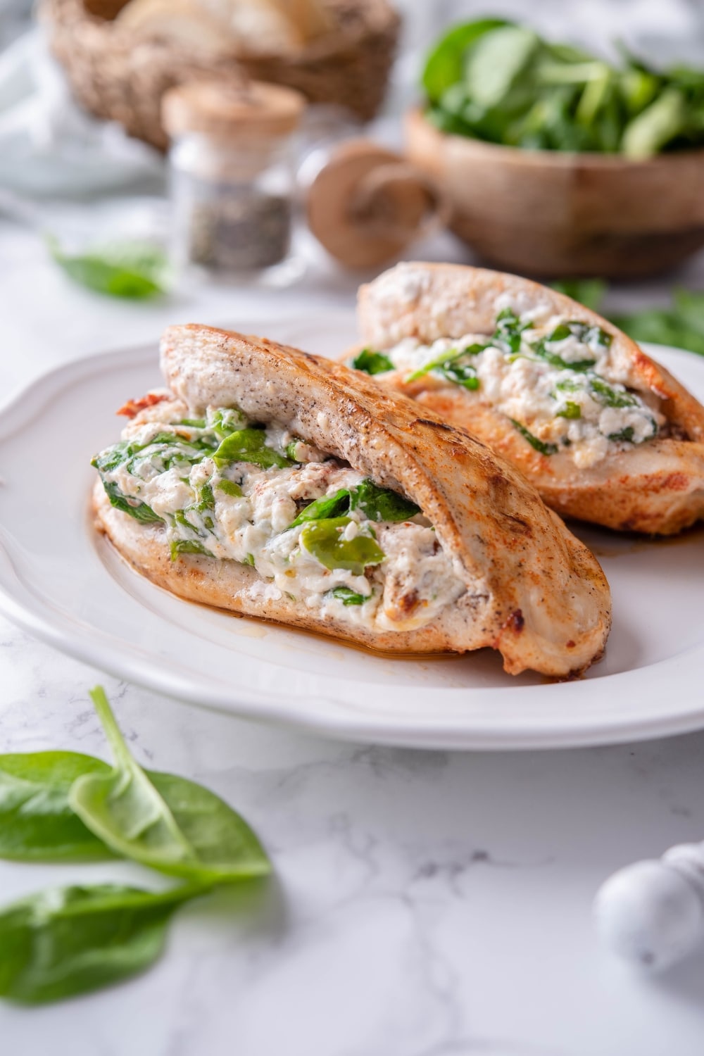 Two stuffed chicken breasts filled with cream cheese, spinach, and sundried tomatoes.