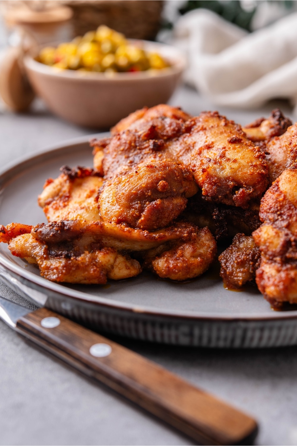 A closer look at baked boneless skinless chicken thighs on a plate.