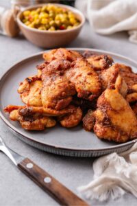Baked boneless skinless chicken thighs on a plate.