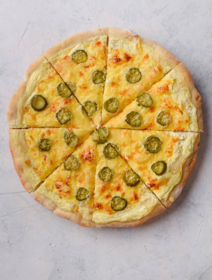 Top view of a whole dill pickle pizza.