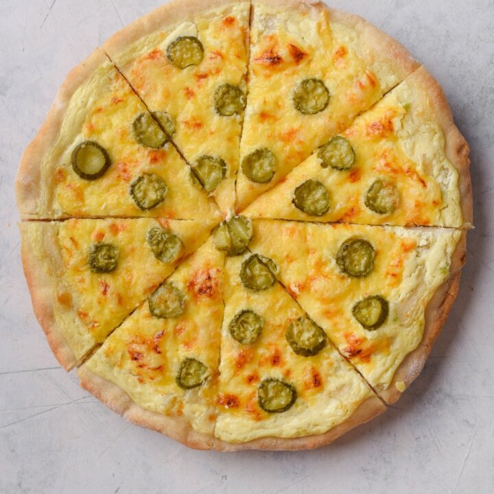 Top view of a whole dill pickle pizza.