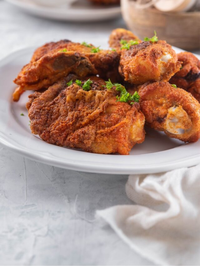 Baked chicken legs and thighs on a plate.