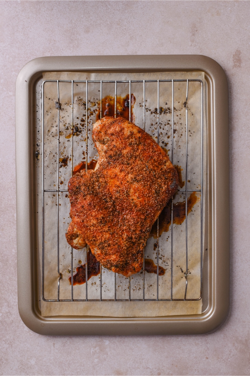 Baked boneless skinless turkey breast on a wire rack over a baking sheet.