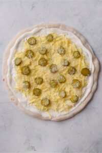 Uncooked dill pickle pizza.