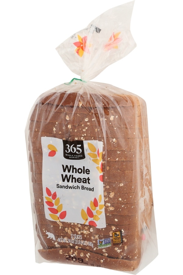 A bag of 365 by Whole Foods Whole Wheat Sandwich Bread.