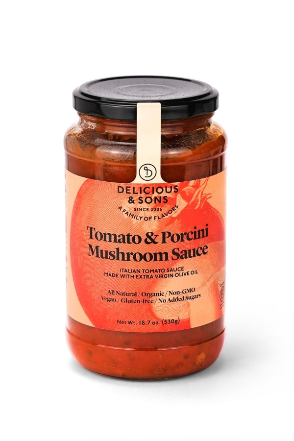 A bottle of Delicious & Sons Tomato & Porcini Mushroom Sauce.