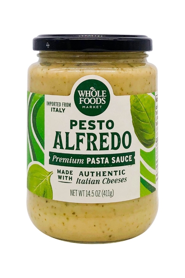 A bottle of whole foods pesto alfredo.