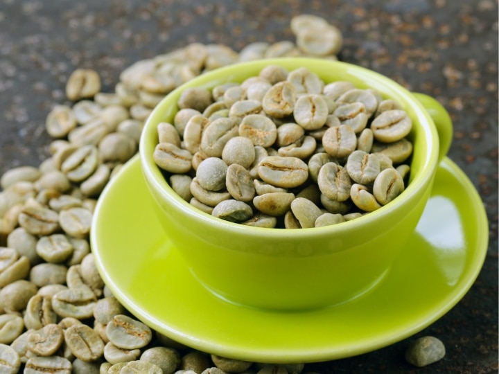 Green coffee bean extract in a green cup on a green plate.