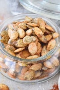 Pumpkin seeds in a glass jar.