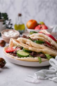 Tomato, cucumber, and sliced beef in pita bread.