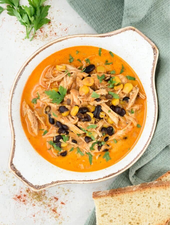 Overhead view of a bowl of chicken enchilada soup.