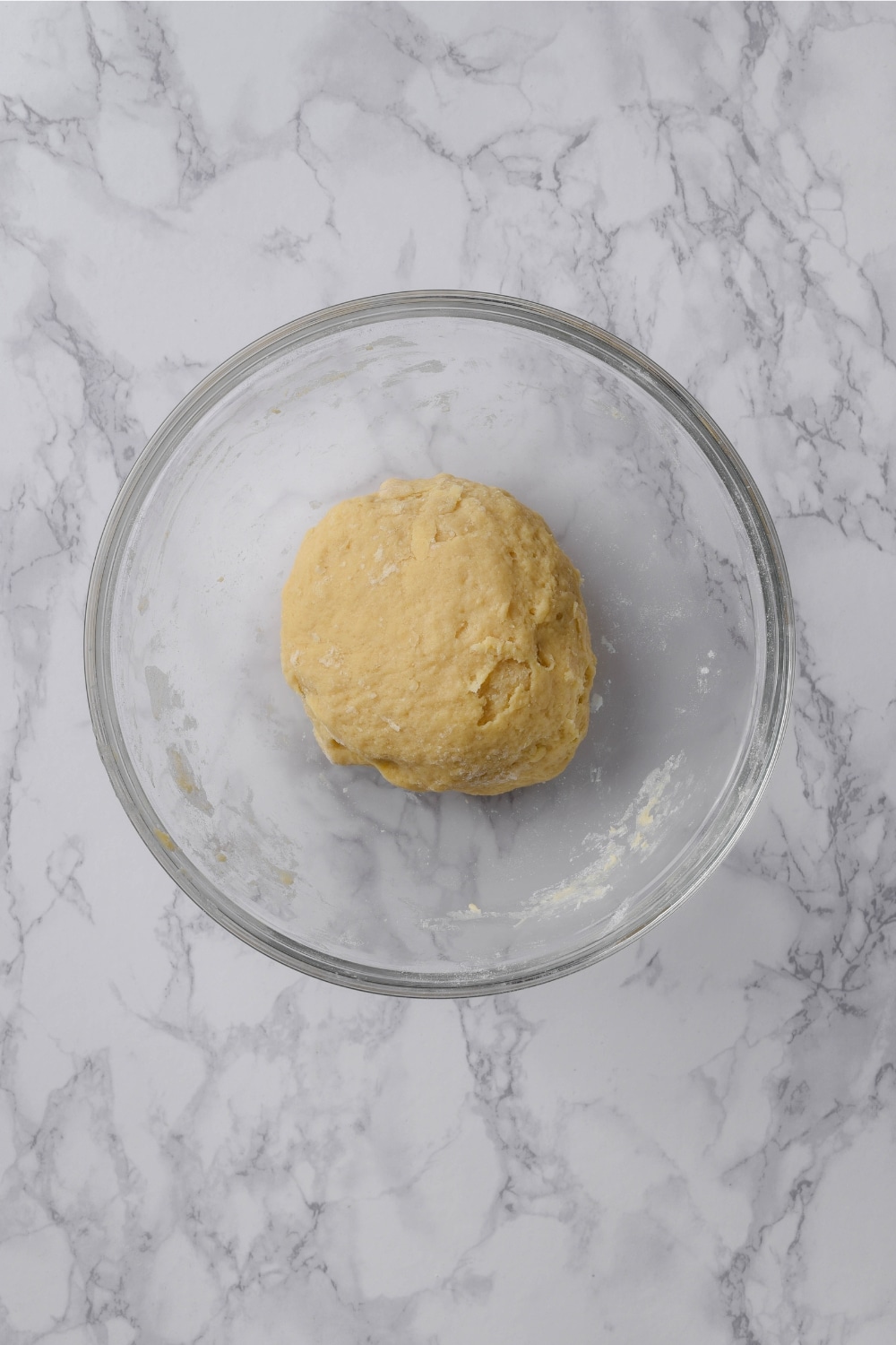 Protein cinnamon roll dough in a glass bowl.