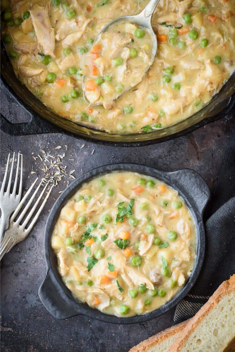 A large pot and smaller serving pot of crustless chicken pot pie.