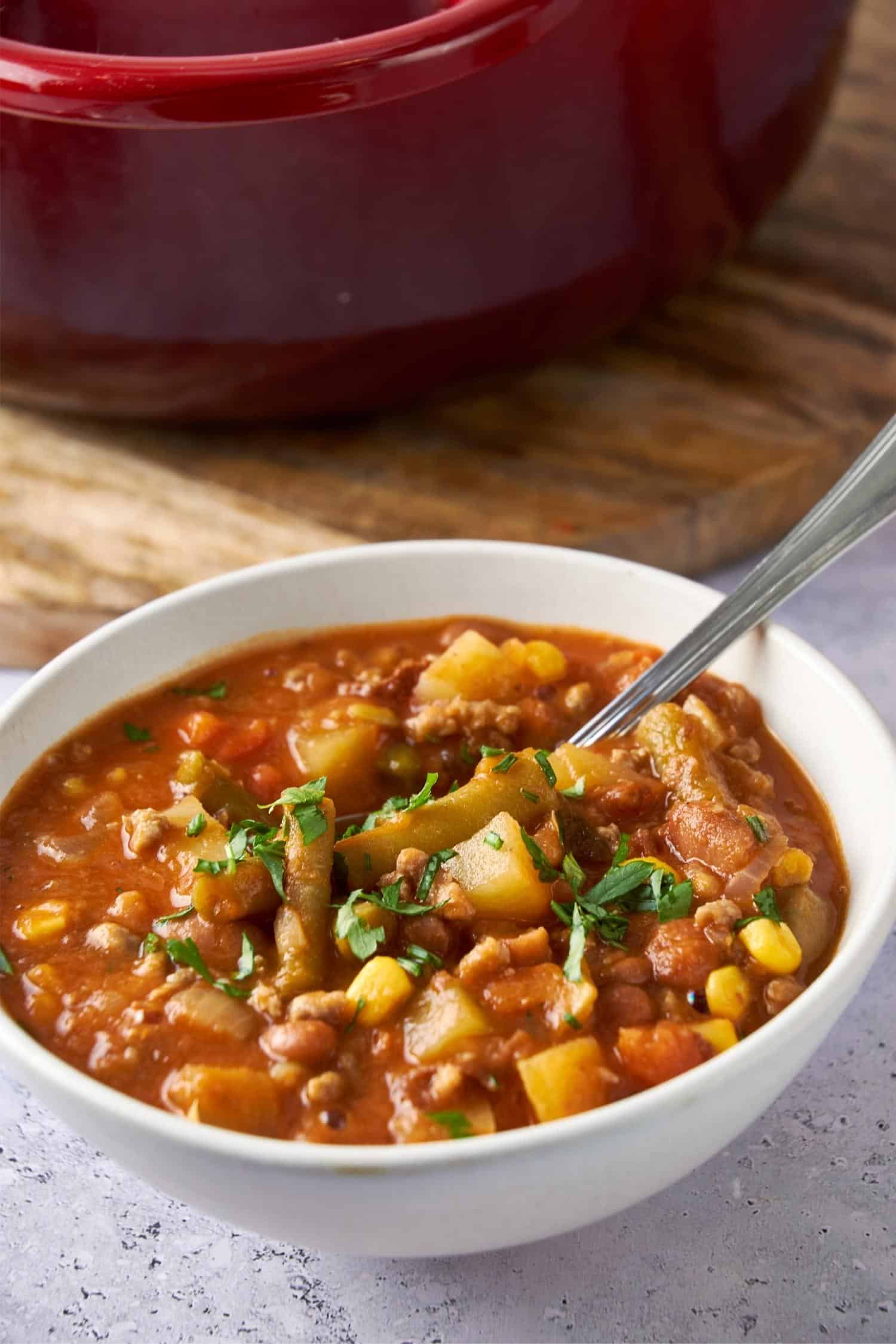 Cowboy soup in a bowl garnished with fresh herbs.