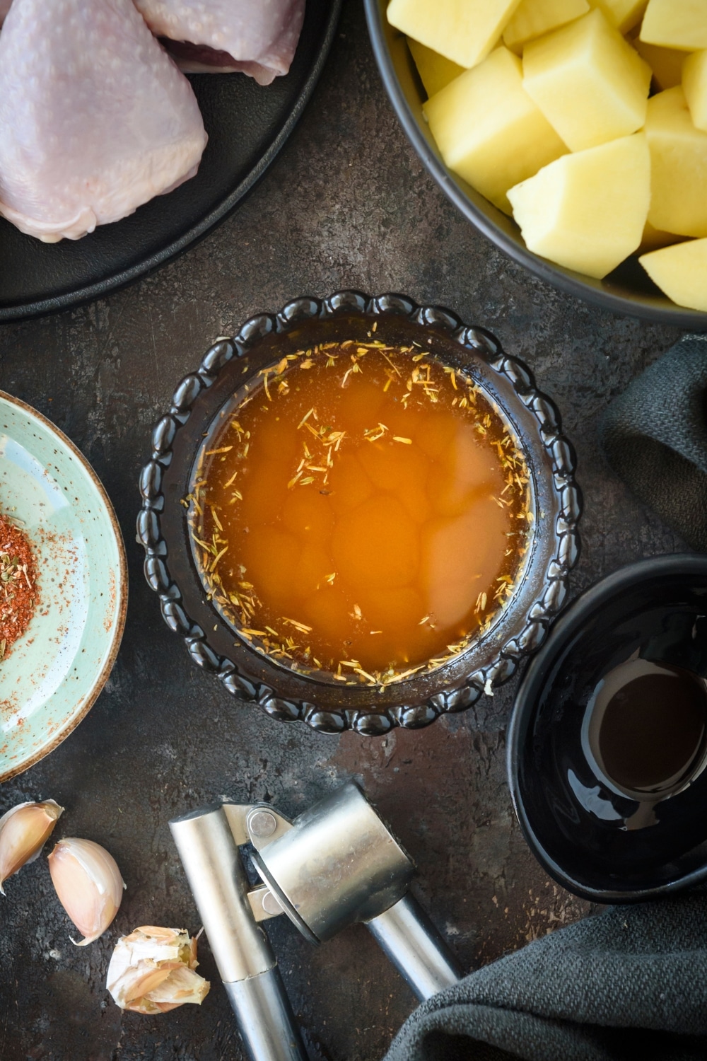 A bowl of broth and seasoning.