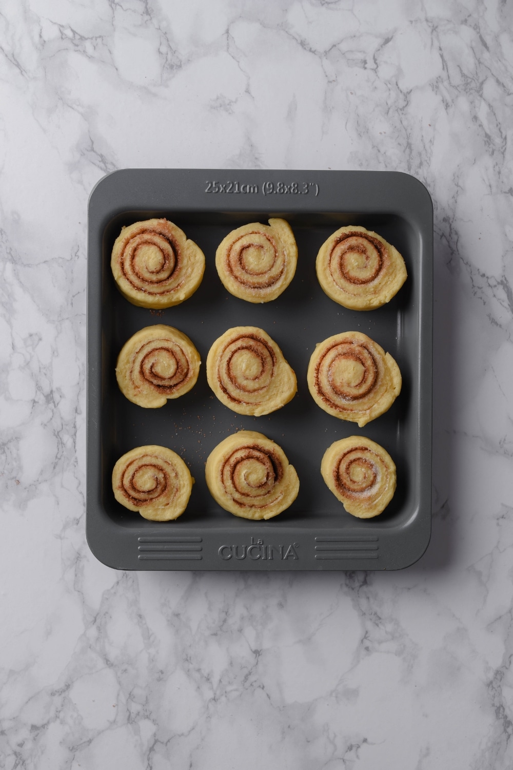 Unbaked protein cinnamon rolls in a baking dish.