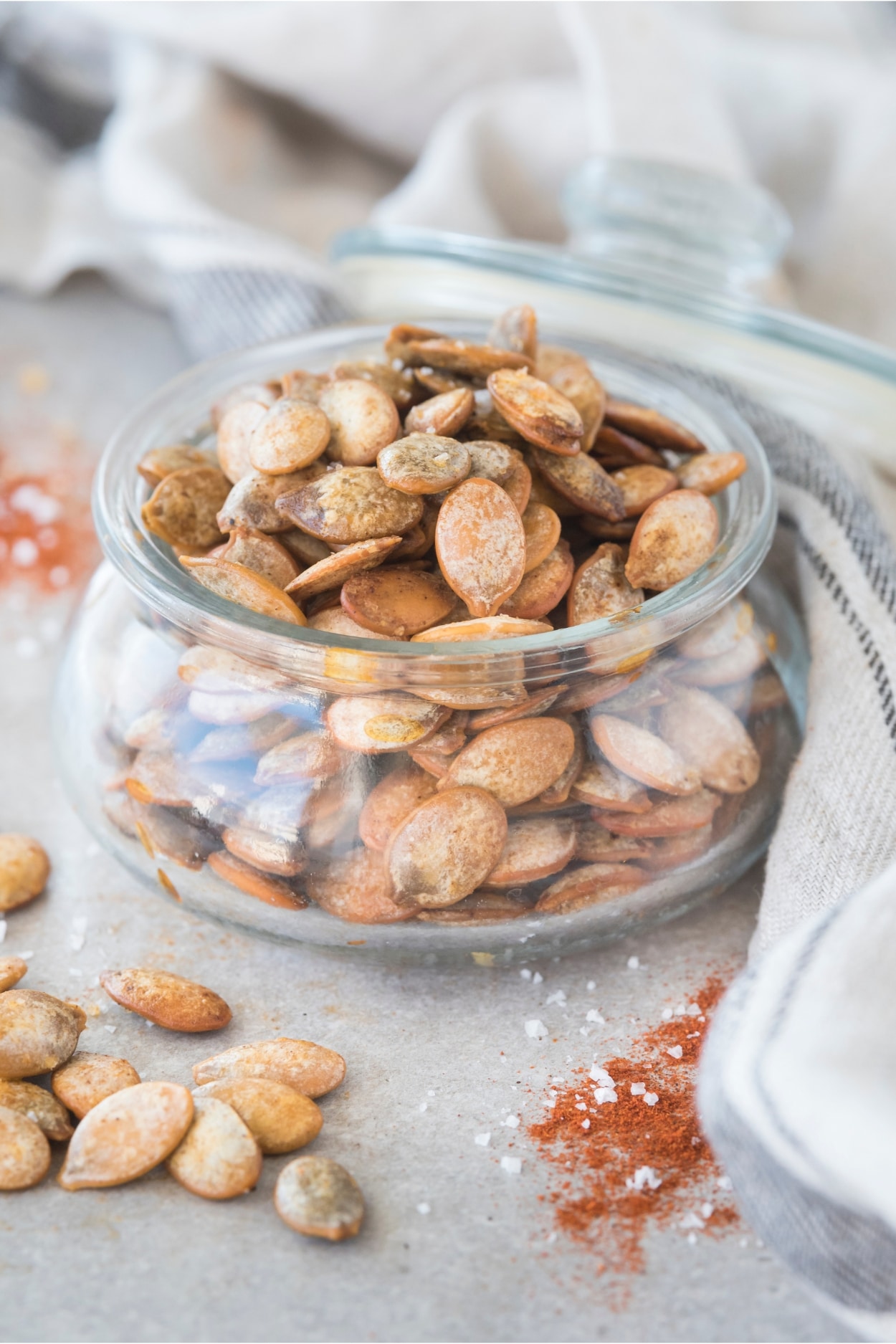 Pumpkin seeds in a glass jar.