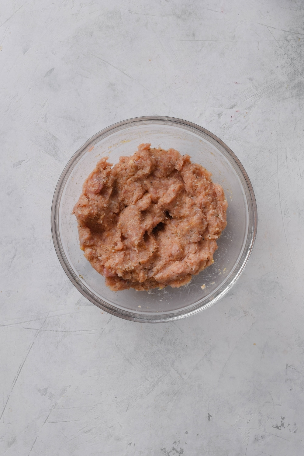 A bowl filled with a ground meat mixture.