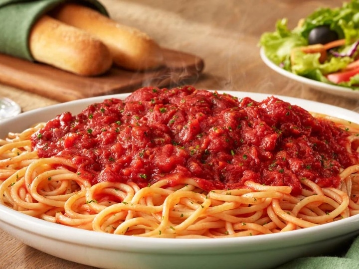 Marinara sauce on top of spaghetti in a bowl.