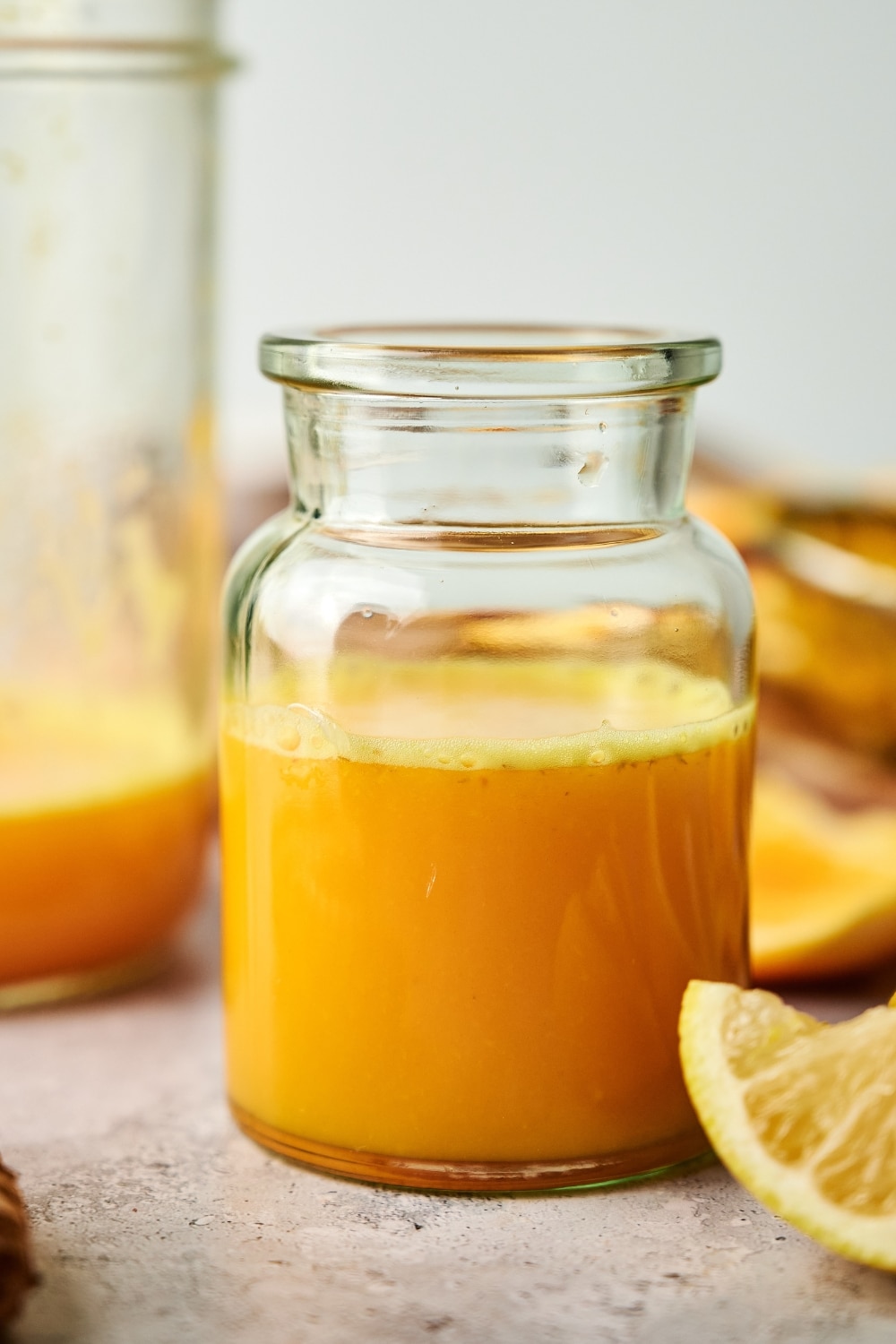 A ginger turmeric shot in a large glass.