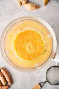 Ginger turmeric shot blended in a blender.