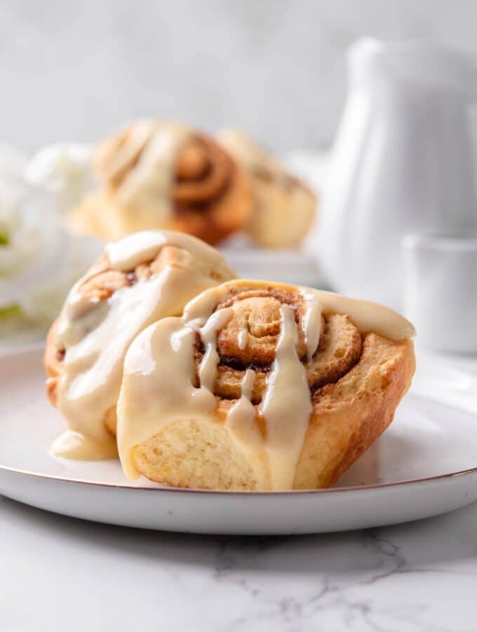 Two protein cinnamon rolls on a white plate.