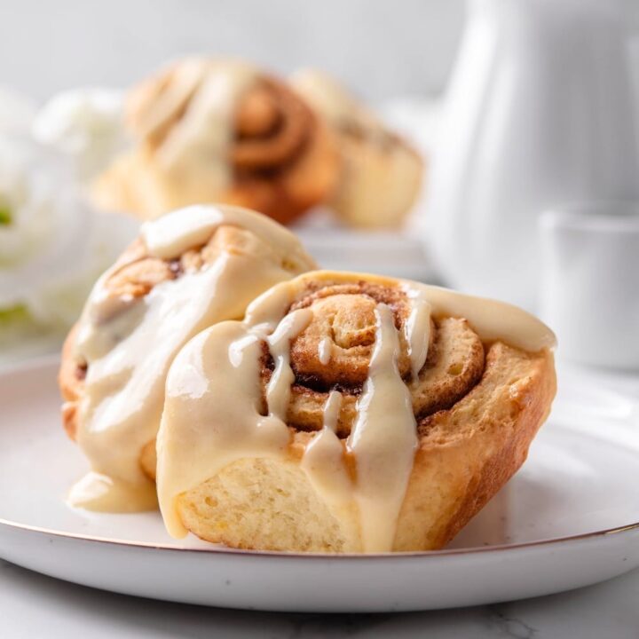 Two protein cinnamon rolls on a white plate.